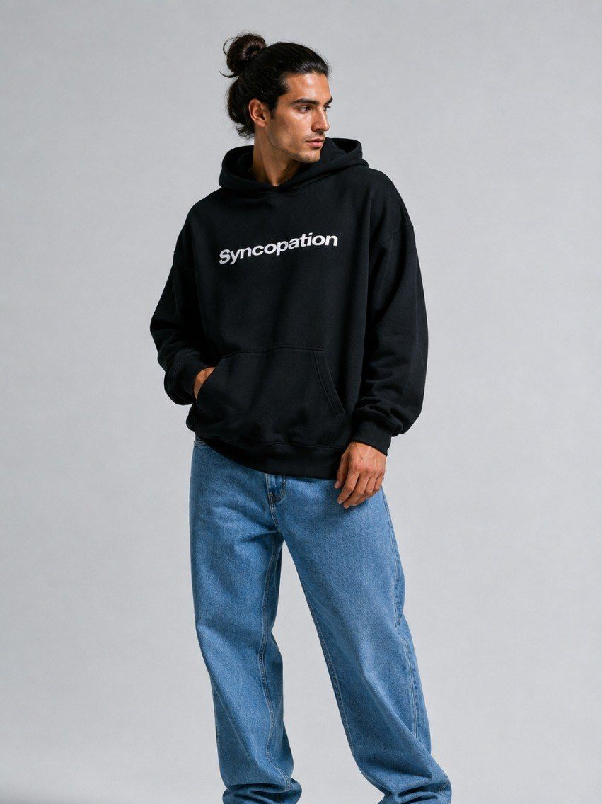 Wordmark hoodie in black, worn with the Syncopation wordmark across the chest
